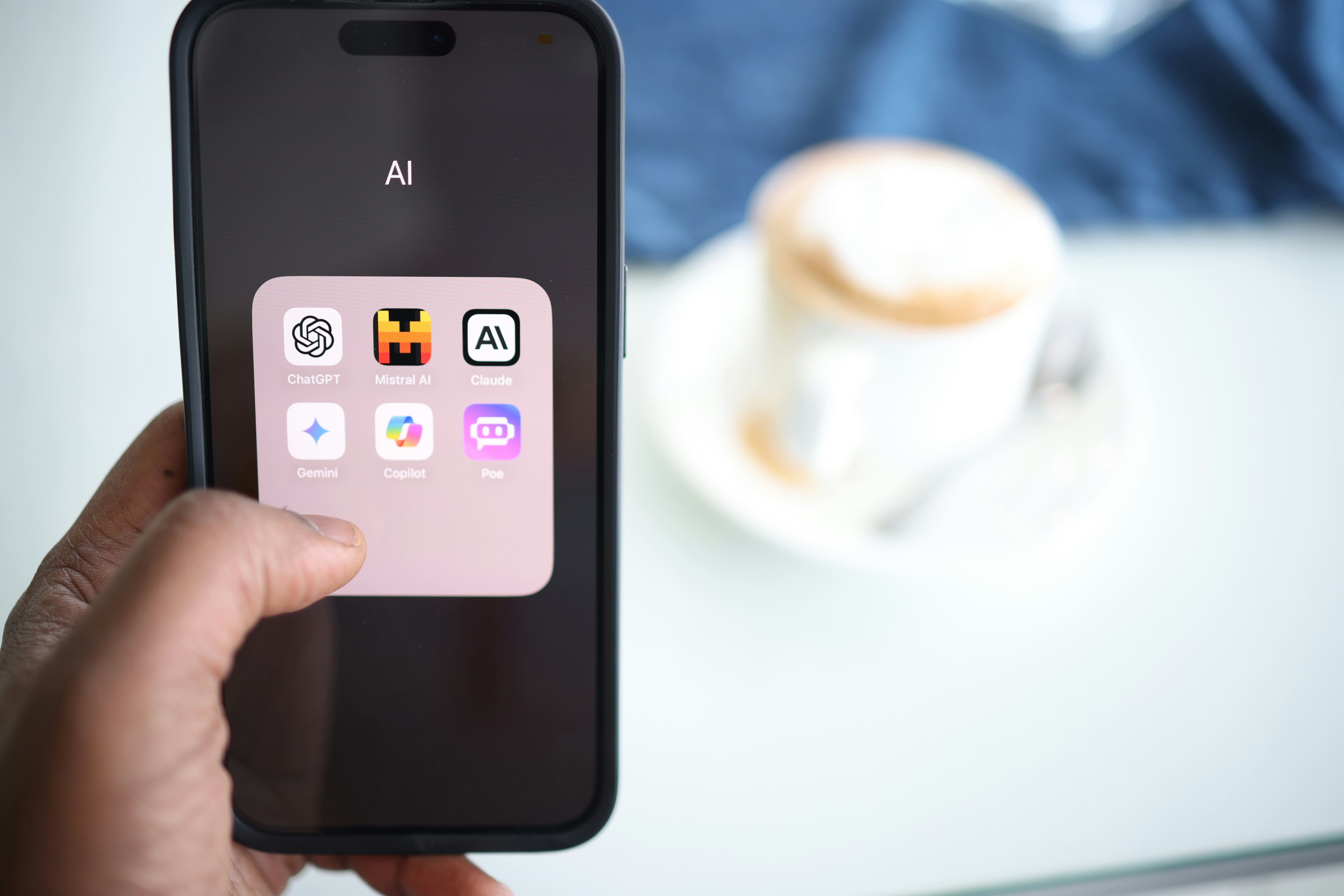 Image of a phone showing app icons of popular AI apps