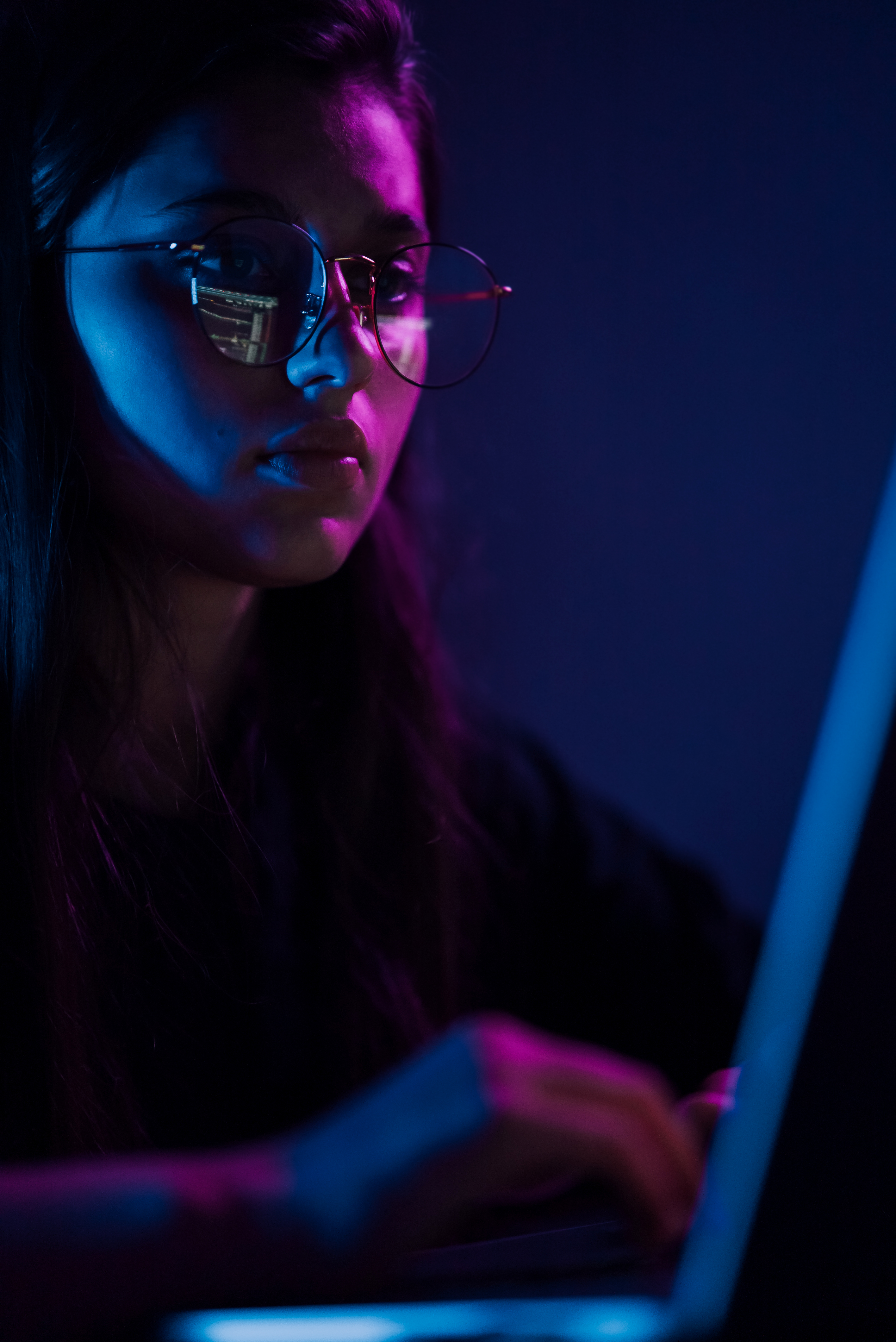 Woman looking at a screen with neon lighting